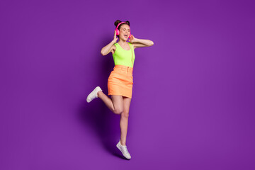 Sticker - Full length body size view of attractive fit dreamy cheery girl jumping listening song singing having fun isolated on bright violet color background