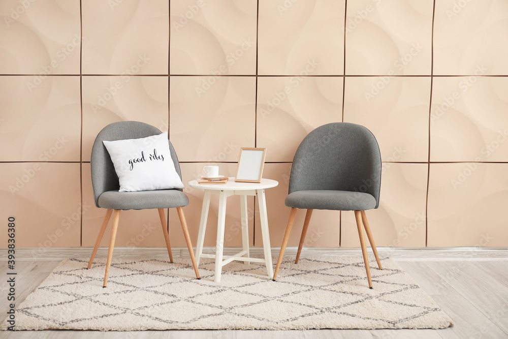 Chairs and table near wall in room