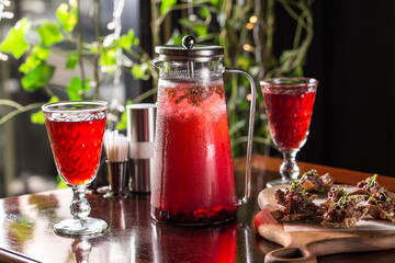 Wall Mural - fresh fruit red punch lemonade jug and glass on wooden table at restaurant