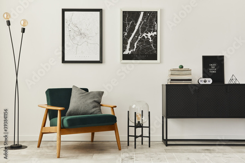 Fotografía Retro and minimalist compositon of living room interior with design armchair, two mock up poster map, lamp, decoration, white wall and personal accessories
