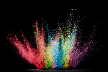 Explosion of colored powder isolated on black background. Abstract colored background