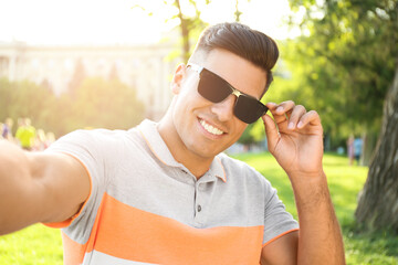 Wall Mural - Handsome man taking selfie in stylish sunglasses