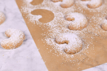 Wall Mural - Close up of crescent shaped christmas cookies called 'Vanillekipferl', a traditional Austrian or German Christmas biscuits with nuts and icing sugar