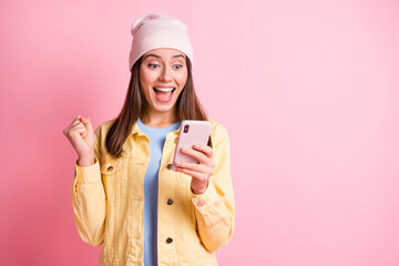Wall Mural - photo of astonished lady won bet fist up look phone open mouth headwear isolated on pastel pink colo