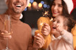 © Pixel-Shot - Happy family celebrating Christmas at home