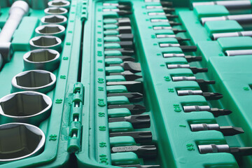 Mechanics Tool Set and Mechanic's Tool Box close-up. Plastic green Storage Box Case. Mechanics Tool Kit. Tool Box with Tools.