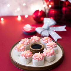 Wall Mural - Sushi rolls topped with pink cream and shrimp