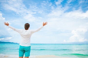 Young man on the white beach on vacation