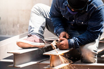 Technician welding steel structure for workshop in Bangkok ,Thailand.