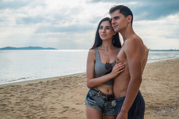 Couple standing on the beach, romantic, young women and men in love