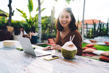 Wall Mural - Optimistic Asian woman working on laptop