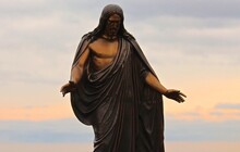 Low Angle View Of Jesus Statue Against Sky During Sunset