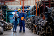 © narong - Soft blur of couple Asian factory man and woman workers discuss together stand in automotive parts workplace area. Concept of good management and support system for industrial business.