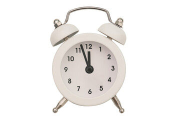 Alarm clock close-up isolated on a white background. White round clock. The hands of an old alarm clock with a bell show the time at twelve o'clock.