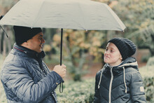 Father And Daughter Talking And Posing With Umbrella, Autumn City Street, Happy People Together, Parent And Children