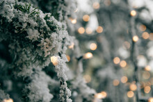 Closeup Photo Of Christmas Tree With Snow, Christmas Ornaments, Christmas Lights, Bokeh Lights.