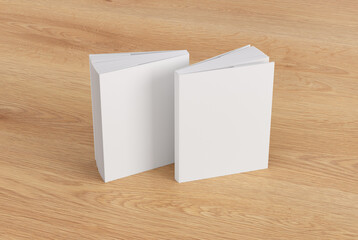 Two softcover or paperback vertical white mockup books standing on the wooden background. Blank front and back cover