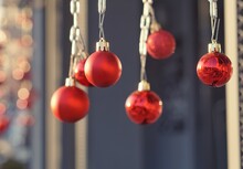 Close-up Of Red Baubles Hanging Indoors