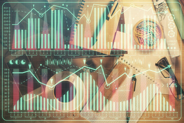 Double exposure of forex graph drawing and work table top veiw. Concept of financial analysis.