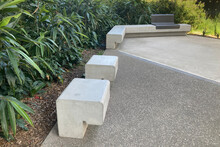 Precast Concrete Park Bench Seats With Lush Garden Bed In The Background. Ismay Reserve Metal And Concrete Street Furniture. Sydney