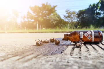 Canvas Print - The chemical bottle is upside down and destroys the environment