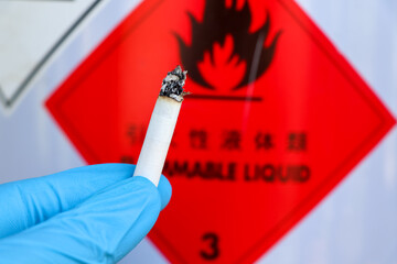 Poster - Hand holding cigarettes near flammable objects