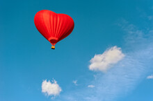 Low Angle View Of Heart Shape Hot Air Balloon Against Blue Sky