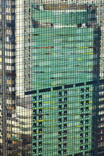 Details Of Colored Residential Building Reflected In Another In Shiodome, Minato Area. The Business District Of Tokyo. Japan