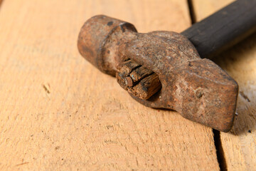 Wall Mural - Old vintage hammer closeup on a wooden background, household hand tools