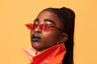 © Leandro Crespi Studio/Stocksy - Orange fashion studio portrait