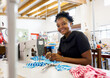 © Micky Wiswedel/Stocksy - African woman sewing in a workshop