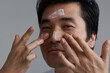 © Leandro Crespi Studio/Stocksy - Asian man skincare routine