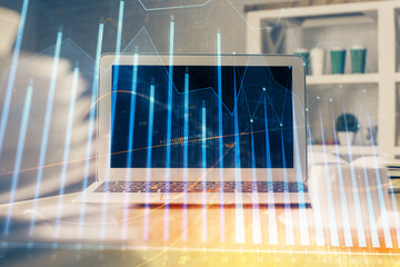 Forex market chart hologram and personal computer background. Double exposure. Concept of investment.