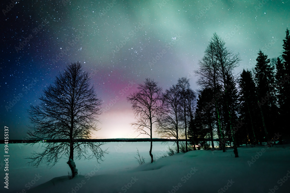 Northern lights Aurora Borealis activity over the lake in winter ...