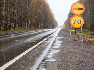 temporary road signs on the road with speed limit. repair of roads