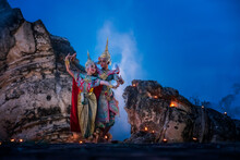 People In Traditional Clothing Dancing On Rock Formation Against Blue Sky At Dusk