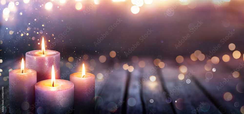 Obraz na płótnie Abstract Advent - Four Purple Candles With Soft Blurry Lights And Glittering On Flames w salonie