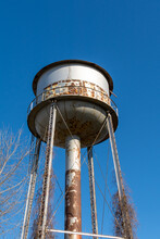 Old Abandoned Rusty Water Tower In The Midwest.