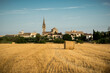 A straw-bale in a straw field with the lovely town of Binissalem and its church in the background, one of the scenic rural areas in Mallorca (Balearic Islands, Spain)