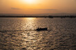 Photograph of a fishing boat in the evening with the sunset in the background