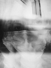 Blurred Motion Of Woman Wearing Mask Against Wall