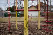 A Derelict Abandoned Playground Sits Empty In An Urban Neighborhood
