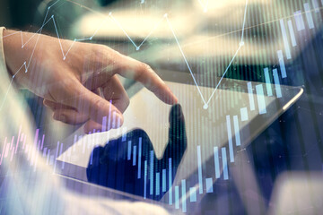 Multi exposure of man's hands holding and using a phone and financial chart drawing. Market analysis concept.