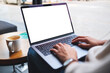 © Farknot Architect - Mockup image of a woman using and typing on laptop computer keyboard with blank white desktop screen