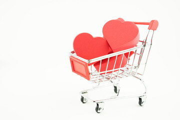 Wall Mural - grocery cart and hearts inside, the concept of love by calculation