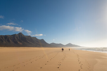 Children walking on Cofete beach, Fuerteventura island