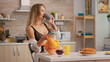 © DC Studio - Attractive blonde lady wearing seductive underwear sitting on chair and searching on smart phone early in morning during breakfast. Sexy woman with tattoos in lingerie relaxing in kitchen