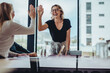© Jacob Lund - Business women high five in a board room meeting