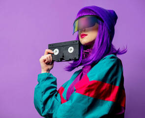 Wall Mural - Style woman in VR glasses and 80s tracksuit with VHS tape