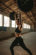 © Jacob Lund - Strong woman lifting weights